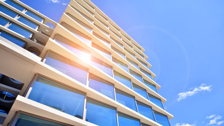 Downtown corporate business district architecture. Glass reflective office buildings against blue sky and sun light. Economy, finance, business activity concept. Abstract modern aの写真素材