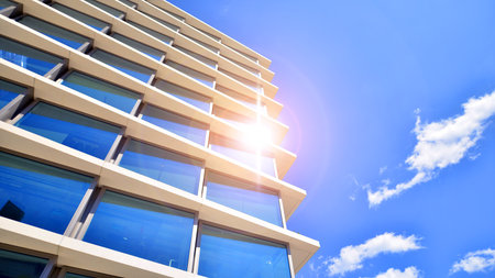 Downtown corporate business district architecture. Glass reflective office buildings against blue sky and sun light. Economy, finance, business activity concept. Abstract modern aの写真素材