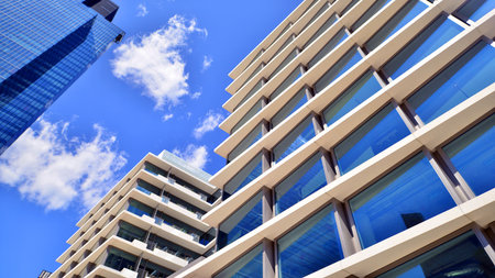 Downtown corporate business district architecture. Glass reflective office buildings against blue sky and sun light. Economy, finance, business activity concept. Abstract modern aの写真素材