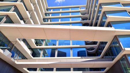 Downtown corporate business district architecture. Glass reflective office buildings against blue sky and sun light. Economy, finance, business activity concept. Abstract modern aの写真素材