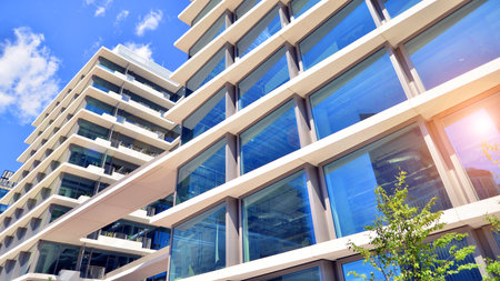 Downtown corporate business district architecture. Glass reflective office buildings against blue sky and sun light. Economy, finance, business activity concept. Abstract modern aの写真素材