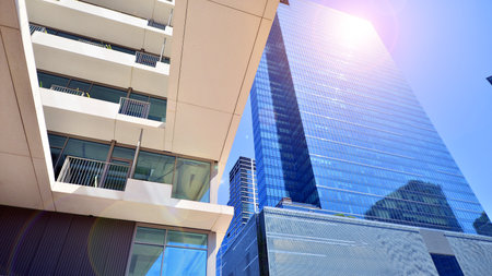 Downtown corporate business district architecture. Glass reflective office buildings against blue sky and sun light. Economy, finance, business activity concept. Abstract modern aの写真素材