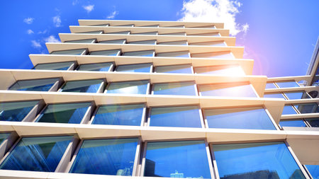 Downtown corporate business district architecture. Glass reflective office buildings against blue sky and sun light. Economy, finance, business activity concept. Abstract modern aの写真素材