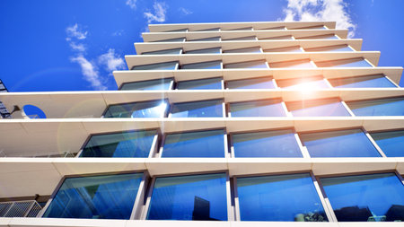 Downtown corporate business district architecture. Glass reflective office buildings against blue sky and sun light. Economy, finance, business activity concept. Abstract modern aの写真素材