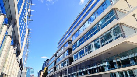 Downtown corporate business district architecture. Glass reflective office buildings against blue sky and sun light. Economy, finance, business activity concept. Abstract modern aの写真素材