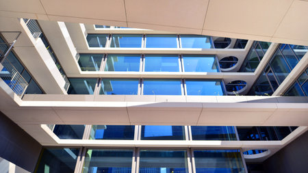 Downtown corporate business district architecture. Glass reflective office buildings against blue sky and sun light. Economy, finance, business activity concept. Abstract modern aの写真素材
