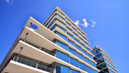 Downtown corporate business district architecture. Glass reflective office buildings against blue sky and sun light. Economy, finance, business activity concept. Abstract modern aの写真素材