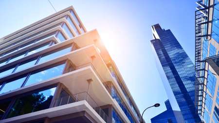 Downtown corporate business district architecture. Glass reflective office buildings against blue sky and sun light. Economy, finance, business activity concept. Abstract modern aの写真素材