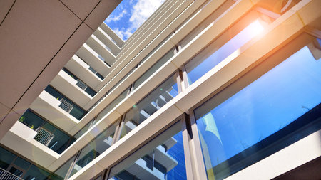 Downtown corporate business district architecture. Glass reflective office buildings against blue sky and sun light. Economy, finance, business activity concept. Abstract modern aの写真素材