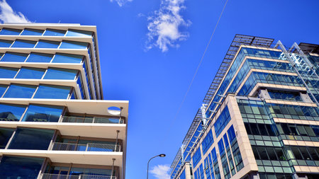 Downtown corporate business district architecture. Glass reflective office buildings against blue sky and sun light. Economy, finance, business activity concept. Abstract modern aの写真素材
