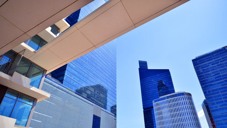 Downtown corporate business district architecture. Glass reflective office buildings against blue sky and sun light. Economy, finance, business activity concept. Abstract modern aの写真素材