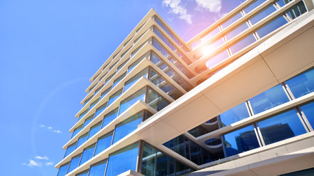 Downtown corporate business district architecture. Glass reflective office buildings against blue sky and sun light. Economy, finance, business activity concept. Abstract modern aの写真素材