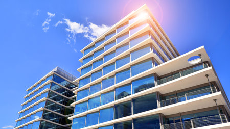 Downtown corporate business district architecture. Glass reflective office buildings against blue sky and sun light. Economy, finance, business activity concept. Abstract modern aの写真素材