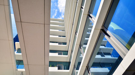 Downtown corporate business district architecture. Glass reflective office buildings against blue sky and sun light. Economy, finance, business activity concept. Abstract modern aの写真素材