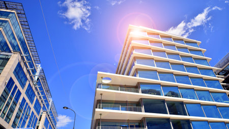 Downtown corporate business district architecture. Glass reflective office buildings against blue sky and sun light. Economy, finance, business activity concept. Abstract modern aの写真素材