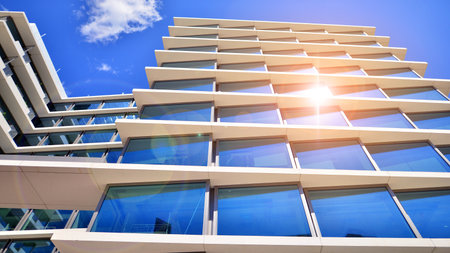 Downtown corporate business district architecture. Glass reflective office buildings against blue sky and sun light. Economy, finance, business activity concept. Abstract modern aの写真素材