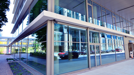 Downtown corporate business district architecture. Glass reflective office buildings against blue sky and sun light. Economy, finance, business activity concept. Abstract modern aの写真素材