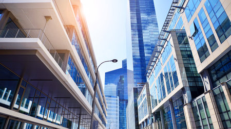 Downtown corporate business district architecture. Glass reflective office buildings against blue sky and sun light. Economy, finance, business activity concept. Abstract modern aの写真素材