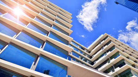 Downtown corporate business district architecture. Glass reflective office buildings against blue sky and sun light. Economy, finance, business activity concept. Abstract modern aの写真素材