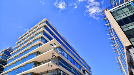 Downtown corporate business district architecture. Glass reflective office buildings against blue sky and sun light. Economy, finance, business activity concept. Abstract modern aの写真素材