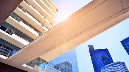 Downtown corporate business district architecture. Glass reflective office buildings against blue sky and sun light. Economy, finance, business activity concept. Abstract modern aの写真素材