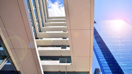 Downtown corporate business district architecture. Glass reflective office buildings against blue sky and sun light. Economy, finance, business activity concept. Abstract modern aの写真素材