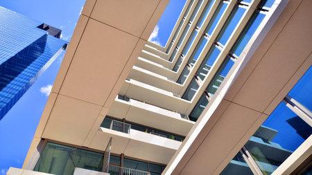 Downtown corporate business district architecture. Glass reflective office buildings against blue sky and sun light. Economy, finance, business activity concept. Abstract modern aの写真素材