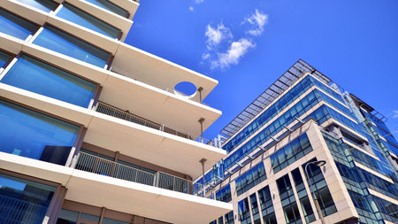Downtown corporate business district architecture. Glass reflective office buildings against blue sky and sun light. Economy, finance, business activity concept. Abstract modern aの写真素材