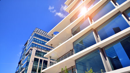 Downtown corporate business district architecture. Glass reflective office buildings against blue sky and sun light. Economy, finance, business activity concept. Abstract modern aの写真素材