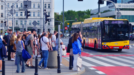 Warsaw, Poland. 5 August 2025. People of different ages crossing the road through. Somer street of a...