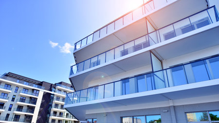 Modern apartment buildings on a sunny day with a blue sky. Facade of a modern apartment building....