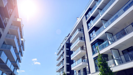 Modern apartment buildings on a sunny day with a blue sky. Facade of a modern apartment building....