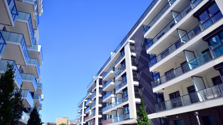 Modern apartment buildings on a sunny day with a blue sky. Facade of a modern apartment building....