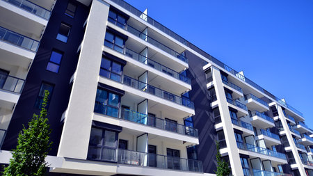Modern apartment buildings on a sunny day with a blue sky. Facade of a modern apartment building....