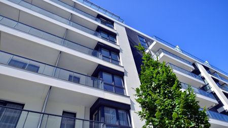 Modern residential building with new apartments in a green residential area. Eco architecture. Green...