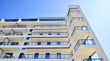 Modern apartment buildings on a sunny day with a blue sky. Facade of a modern apartment building....
