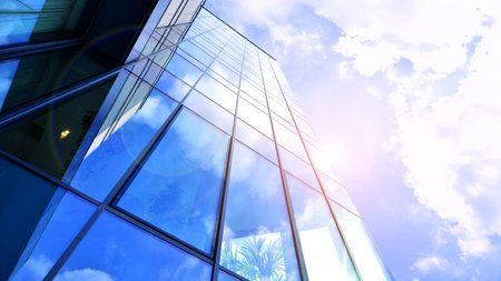 Modern office building with glass facade. Transparent glass wall of office building. Reflection of...