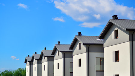 Terraced family homes in newly developed housing estate. The real estate market in the suburbs. New...