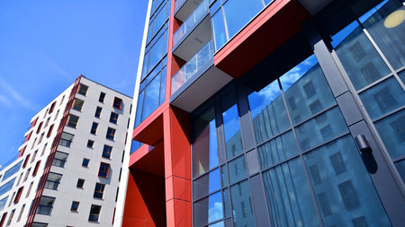 Exterior of a high modern multi-story apartment building - facade, windows and balconies. Timeless...