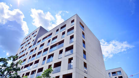 Modern apartment buildings on a sunny day with a blue sky. Facade of a modern apartment building....