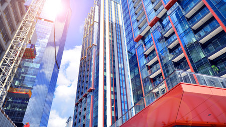Exterior of a high modern multi-story apartment building - facade, windows and balconies. Timeless...