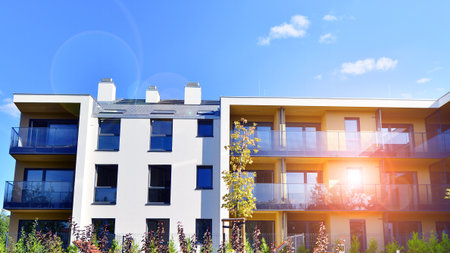 European residential architecture harmonizing with nature. Eco-friendly living in city with greens. Eco apartment building saving energy and fresh air concept.の写真素材