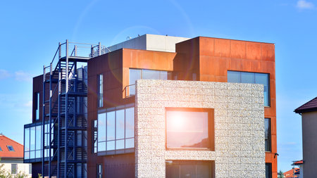Office building facade covered in unique Corten steel, stones and glass materials.の写真素材
