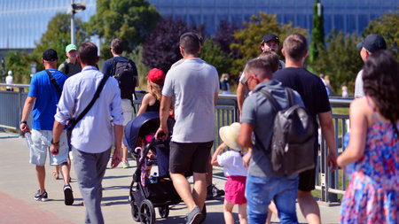 Warsaw, Poland. 15 August 2025. Tourists and residents crossing crowded Swietokrzyski Bridge. Groups...