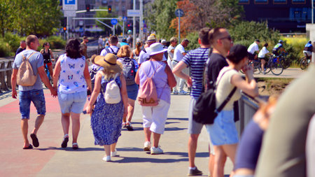 Warsaw, Poland. 15 August 2025. Tourists and residents crossing crowded Swietokrzyski Bridge. Groups...