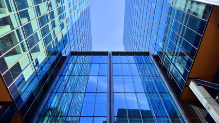 Bottom up view of modern glass office building. Commercial real estate. New commercial office...