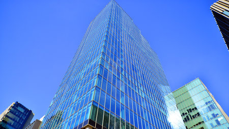 Bottom up view of modern glass office building. Commercial real estate. New commercial office...