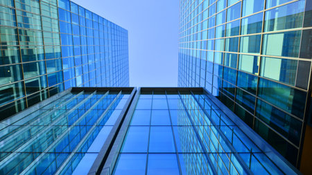 Bottom up view of modern glass office building. Commercial real estate. New commercial office...