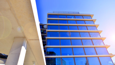 A modern corporate hub in the city center. The structure features a glass and concrete walls, showcasing contemporary architecture. Modern luxury office building.の写真素材
