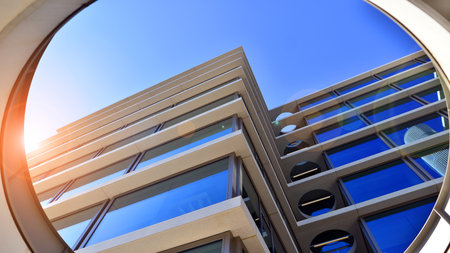 A modern corporate hub in the city center. The structure features a glass and concrete walls, showcasing contemporary architecture. Modern luxury office building.の写真素材